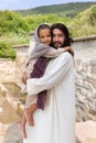 Jesus carrying a little girl Royalty Free Stock Photo