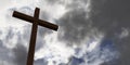 Jesus Christ christian crucifix or cross in front of stormy sky with dark clouds, god, resurrection or christianity concept