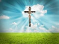 Jesus Christ on cross radiates light in sky over Royalty Free Stock Photo