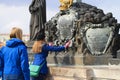 Jesus Christ on Cross statuary group on Charles bridge in Prague with tourists Royalty Free Stock Photo