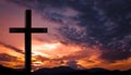 Jesus Christ cross, wooden crucifix on a heavenly background with dramatic light and clouds and colorful orange sunset