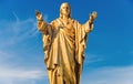 Jesus Christ golden statue over blue sky Royalty Free Stock Photo