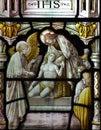 Jesus Christ helping a poor man (in stained glass) Royalty Free Stock Photo