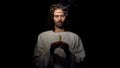 Jesus Christ holding blown candle, praying for people sins expiation, salvation