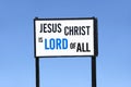 Jesus Christ is lord of all religious sign board post against blue sky Royalty Free Stock Photo