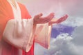 Jesus Christ reaching out his hands and praying against blue sky Royalty Free Stock Photo