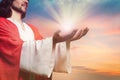 Jesus Christ reaching out his hands and praying at sunset Royalty Free Stock Photo