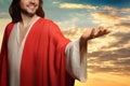 Jesus Christ reaching out his hands and praying at sunset Royalty Free Stock Photo