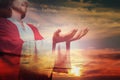 Jesus Christ reaching out his hands and praying at sunset, double exposure Royalty Free Stock Photo