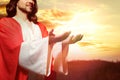 Jesus Christ reaching out his hands and praying at sunset Royalty Free Stock Photo