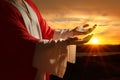 Jesus Christ reaching out his hands and praying at sunset Royalty Free Stock Photo