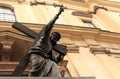 Jesus Christ statue with cross and pointing hand finger against cathedral building in Warsaw, Poland.