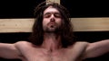 Jesus closed eyes on cross dark background, forgiveness of sins, religious love