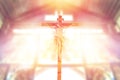 Jesus on the cross in church with ray of light from stained glass, image of the crucifixion Royalty Free Stock Photo