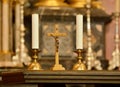 Old Crucifix, jesus on the cross in church with two candles Royalty Free Stock Photo