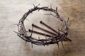 Jesus Crown Thorns and nails on Old and Grunge Wood Background. Vintage Retro Style. Royalty Free Stock Photo