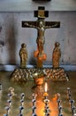 Jesus on crucifix cross with Virgin Mary and candle offerings in church Tbilisi Georgia