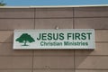 jesus first christian ministries rectangle sign in green writing on white