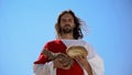 Jesus holding bread and bottle of wine, sharing sacramental meal, Holy Eucharist