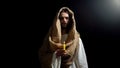 Jesus holding candle, praying for people sins expiation, belief and kindness Royalty Free Stock Photo