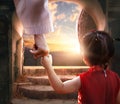 Easter and Good Friday concept, Jesus holding child's hand with empty tomb of Jesus Christ at sunset background Royalty Free Stock Photo