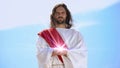 Jesus holding spiritual light against sky, concept of healing, religious miracle