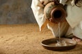 Jesus pouring water from a jar Royalty Free Stock Photo