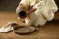 Jesus pouring water from a jar Royalty Free Stock Photo