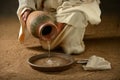 Jesus Pouring Water on Pan Royalty Free Stock Photo