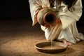 Jesus Pouring Water into Pan Royalty Free Stock Photo