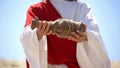 Jesus in robe showing bottle of wine on camera, Eucharist in Catholic church