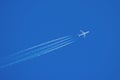 Jet aircraft flying at high altitude with contrails Royalty Free Stock Photo