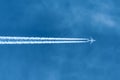 Jet aircraft flying at high altitude with contrails Royalty Free Stock Photo
