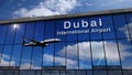 Airplane landing at Dubai mirrored in terminal