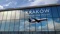 Airplane landing at Krakow, Cracow Poland airport mirrored in terminal