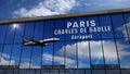 Airplane landing at Paris France mirrored in terminal Royalty Free Stock Photo