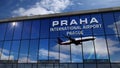 Airplane landing at Praha Prague in Czech mirrored in terminal