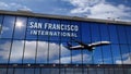 Airplane landing at San Francisco California mirrored in terminal