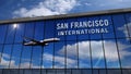 Airplane landing at San Francisco California mirrored in terminal