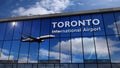 Airplane landing at Toronto Canada mirrored in terminal