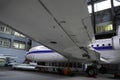 A Jet airliner is on maintenance in the hangar.