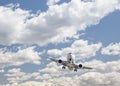 Jet Airplane Landing with Dramatic Clouds Behind