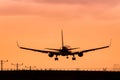 Jet Airplane Landing at Sunset Royalty Free Stock Photo