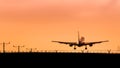 Jet Airplane Landing at Sunset Royalty Free Stock Photo