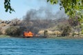 Jet boat on fire in the Colorado River Royalty Free Stock Photo