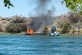 Jet boat on fire in the Colorado River Royalty Free Stock Photo