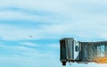 Jet bridge after commercial airline take off at the airport and the plane flying in the blue sky and white clouds. Aircraft Royalty Free Stock Photo