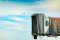 Jet bridge after commercial airline take off at the airport and the plane flying in the blue sky and white clouds. Aircraft Royalty Free Stock Photo