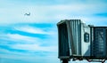 Jet bridge after commercial airline take off at the airport and the plane flying in the blue sky and white clouds. Aircraft Royalty Free Stock Photo