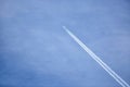 A commercial aircraft with contrails.